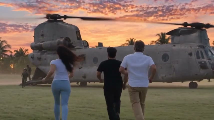Deep, Nora and Otto run across a lawn at sunset toward a waiting Chinook helicopter.
